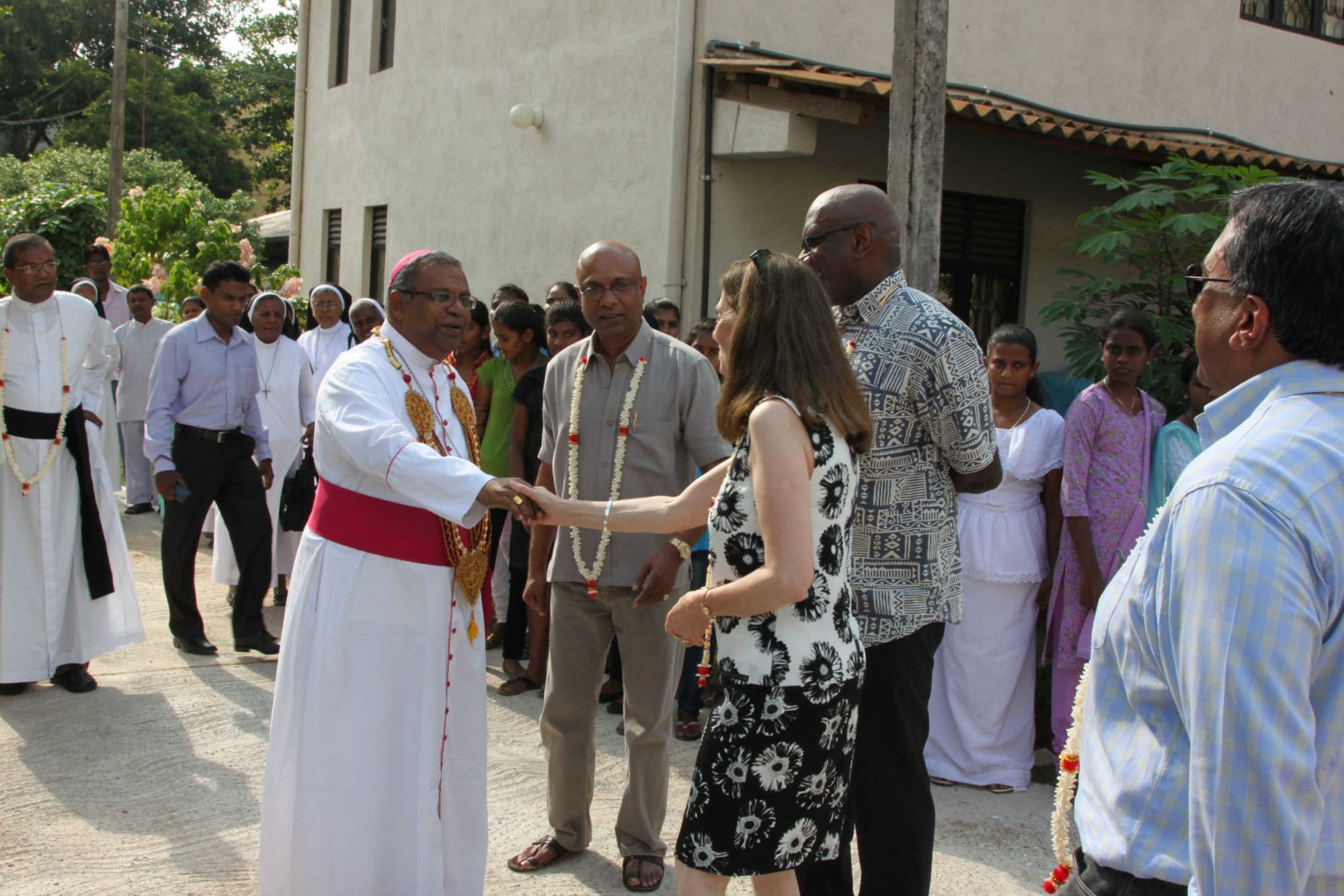 Frances Chanmugam meeting the priest at the home